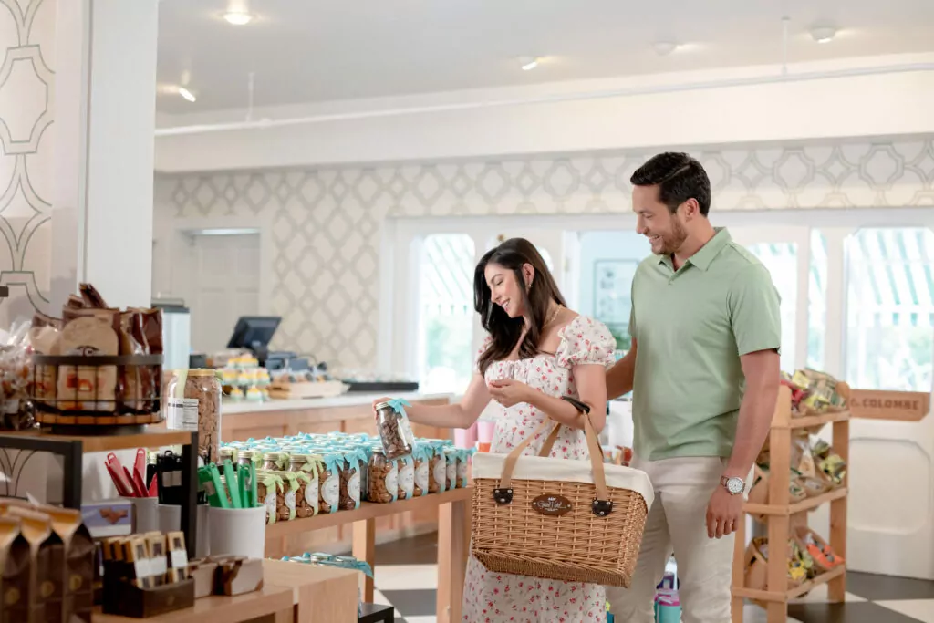 A young couple at a hotel gift shop looking at baked goods - The Grand Hotel Hospitality Marketing